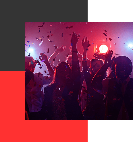 A group of people in a room with lights on.