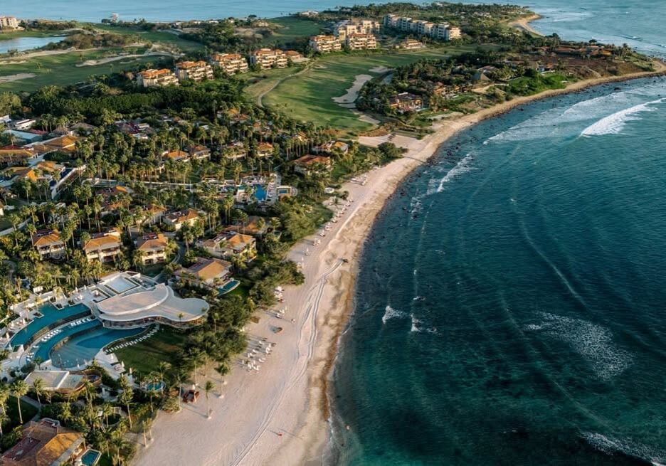 Aerial view of tropical beachfront resort.