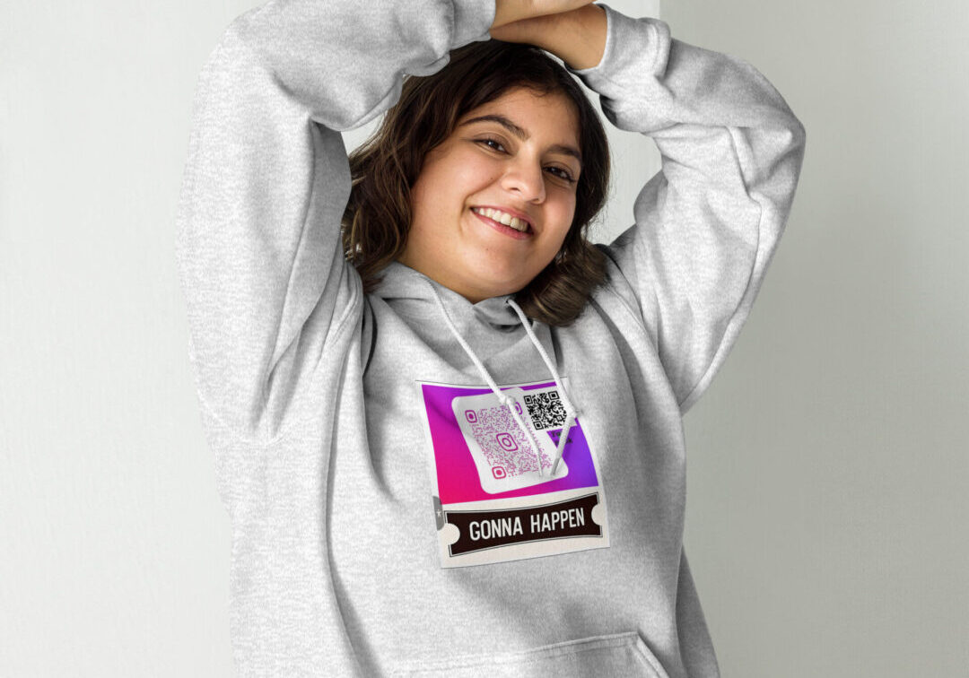 Smiling person wearing hoodie with graphic